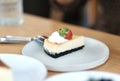 Close up of Strawberry cheesecake on a white plate in a coffee shop. Royalty Free Stock Photo