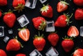 A close-up of a strawberry with ice cubes on a black background Royalty Free Stock Photo