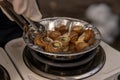 Close up street fast food take away portion of cooked escargot snails with French herbs. cooking on a miniature electric stove Royalty Free Stock Photo