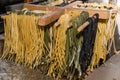 Close up. Street food, cooking pasta. Freshly prepared tagliatelle is dried in a wooden dryer