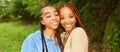 Close up street style portrait beautiful young African American female black couple. Braids hair, perfect white teeth Royalty Free Stock Photo