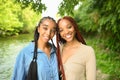 Close up street style portrait beautiful young African American female black couple. Braids hair, perfect white teeth Royalty Free Stock Photo