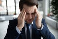 Close up stressed businessman touching temples, suffering from headache Royalty Free Stock Photo