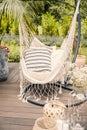 Close-up of a string hammock with cushions on a deck in a yard d