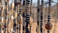 Close up of strings of African necklaces made from beads and seeds on display at an outdoor market in Namibia. Background blurred Royalty Free Stock Photo