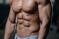 Close up strong abs guy showing in the gym muscles Royalty Free Stock Photo