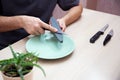 Strong male hands sharpen a kitchen metal knife with a grindstone. Home household knife sharpening Royalty Free Stock Photo