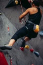 Close up of a woman rock climber with a harness and rope for safety