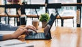 Close up of student girl hands comparing notes on digital tablet sitting on a desk. female using tablet at cafe Royalty Free Stock Photo