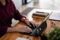 Close up of student girl hands comparing notes on digital tablet sitting on a desk. female using tablet at cafe Royalty Free Stock Photo