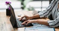 Close up of student girl hands comparing notes on digital tablet sitting on a desk. female using tablet at cafe Royalty Free Stock Photo