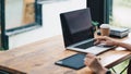 Close up of student girl hands comparing notes on laptop computer and digital tablet sitting on a desk. female using Royalty Free Stock Photo