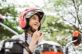 Close up of student girl tightening helmet strap on motorbike
