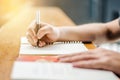 Close up of student hand writing on book with pen Royalty Free Stock Photo