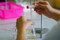 Close-up of a student performing an acid-base titration experiment. Royalty Free Stock Photo