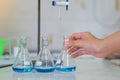 Close-up of a student performing an acid-base titration experiment. Royalty Free Stock Photo