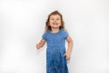 Close up studio portrait of an adorable young kid girl laughing with excitement, happy jump, isolated on white backgroud. Human
