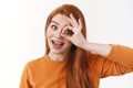 Close-up studio portrait enthusiastic cute redhead woman with positive attitude, make okay gesture, show ok sign over