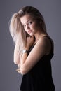 Close up studio portrait of a pretty blonde woman, smiling and l