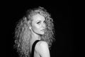 Portrait of a pretty curly blonde woman, wearing black dress Royalty Free Stock Photo