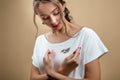 Close-up studio portrait of young beautiful fashionable woman in stylish accessories. Bird-shaped brooch attached to a white Royalty Free Stock Photo