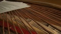 Close up studio shot of classical piano. Shot inside the piano with composition paper sheets with musical notes laying