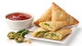 Crispy Golden Samosas with Spicy Green Chilies and Dipping Sauce Royalty Free Stock Photo