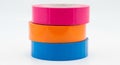 Stack of Three Rolls of Brightly Colored Tape on White Background adhesive sticky Royalty Free Stock Photo