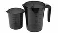 Two Black Transparent Measuring Cups with Graduated Markings on White Background Royalty Free Stock Photo