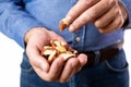 Close Up Studio Shot Of Mature Man Eating Brazil Nuts