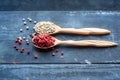 Two wooden spoons with pink and white peppercorn Royalty Free Stock Photo