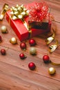 Small brown present gift with red ribbon bow tie placed on big paper wrapped box on dark brown pattern wooden table with glossy Royalty Free Stock Photo