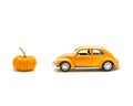 Close-up studio shot small orange toy car with mini pumpkin isolated on white Royalty Free Stock Photo