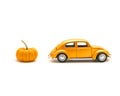 Close-up studio shot small orange toy car with mini pumpkin isolated on white Royalty Free Stock Photo