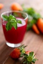 Closeup studio shot two glasses of freshly blended squeezed decorated with strawberry and carrot healthy diet vegan drink fresh