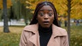 Close-up stunned african american woman standing outdoor looking at camera with eyes wide open and mouth feeling shock Royalty Free Stock Photo