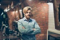 Close up of a stunning look of a red bearded blond guy with trendy hairdo in a barber shop. Looking so fashionable and