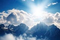 close-up of stunning mountain range with clouds, sun, and blue skies Royalty Free Stock Photo