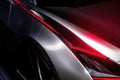 A close up of a stunning silver race car with a cherry red racing stripe down its side. Speed drive concept. AI