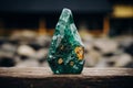 Close-up of stunningly large emerald with radiant golden inclusions on softly blurred background