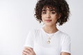 Close-up stylish attractive satisfied female young start-up entrepreneur, curly afro hairstyle, trendy necklaces smiling