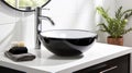 Close up of stylish black ceramic round vessel sink and chrome faucet on white vanity Royalty Free Stock Photo