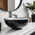 Close up of stylish black ceramic round vessel sink and chrome faucet on white vanity. Minimalist interior design of modern Royalty Free Stock Photo