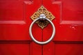 close-up of a stylish doorknocker on a red door Royalty Free Stock Photo