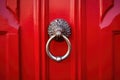 close-up of a stylish doorknocker on a red door