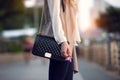 Close up of stylish female black leather bag outdoors. Fashionable and luxury style expensive female bag