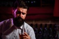 Close up of a stylish handsome bearded man enjoying a brandy or whiskey. Royalty Free Stock Photo