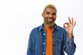 Close up of stylish hipster guy shows okay sign. Handsome african american man with yellow beard and hairstyle, makes ok Royalty Free Stock Photo