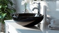 Close up of stylish black ceramic round vessel sink and chrome faucet on white vanity Royalty Free Stock Photo