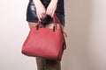 Close up stylish woman in black dress holding red bag